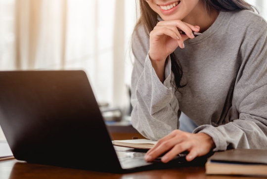 woman on laptop smiling