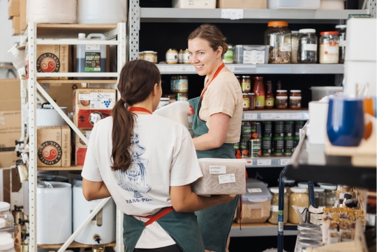 two waitresses in grocery store smiling