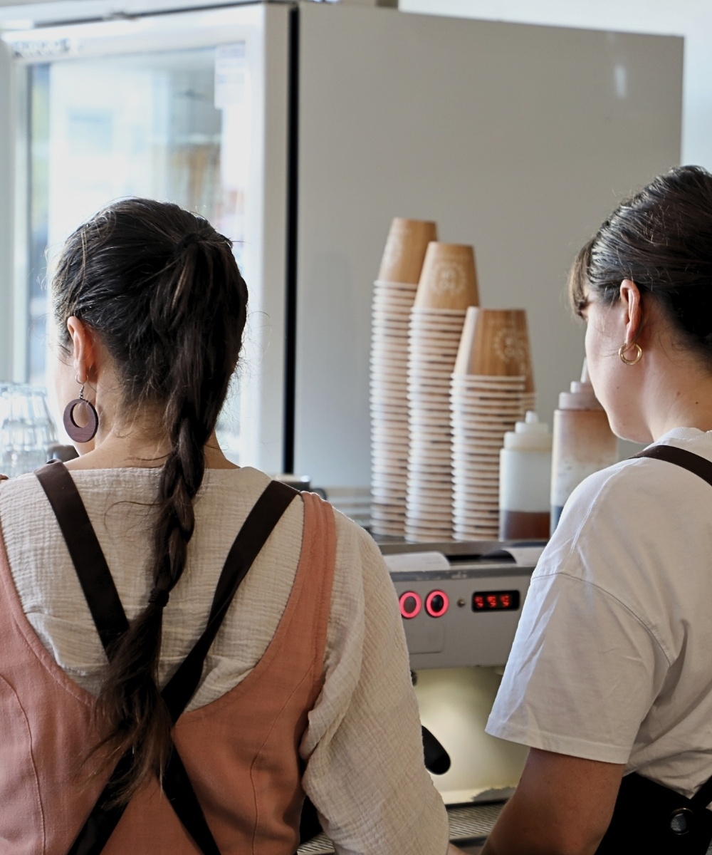 two baristas making coffee