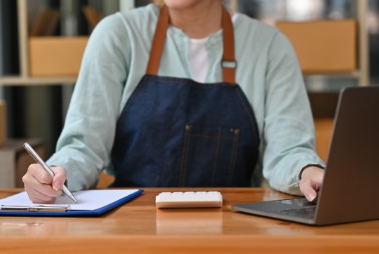person signing paper
