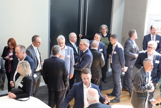 group of people standing in an event space